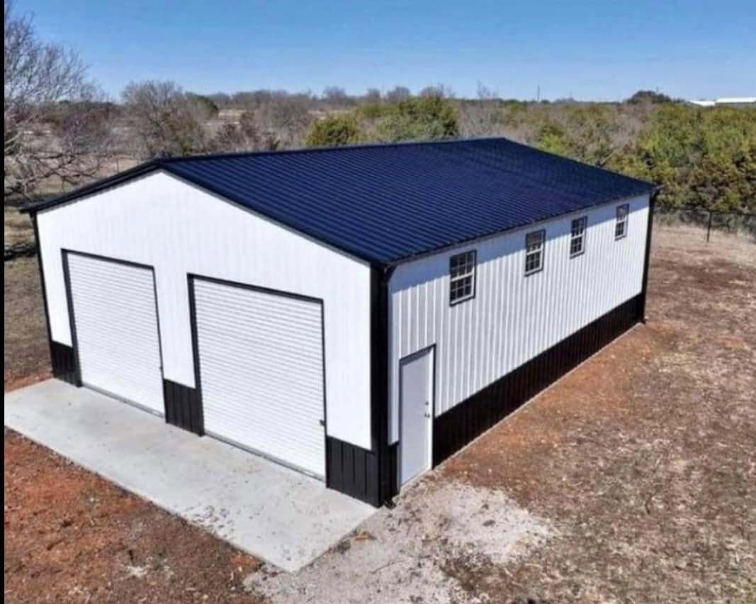 White metal garage with navy roof and two white roll-up doors
