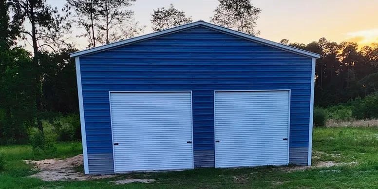 Blue metal storage garage with two white roll-up doors